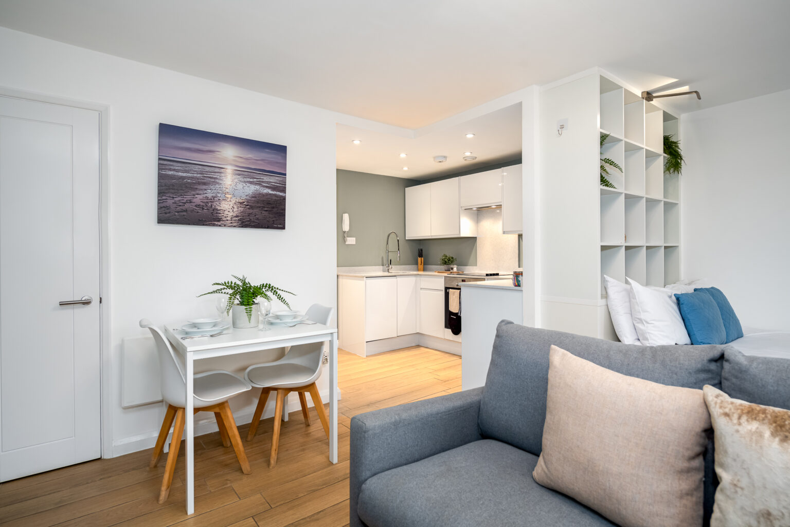 open plan living area with grey sofa and dining area